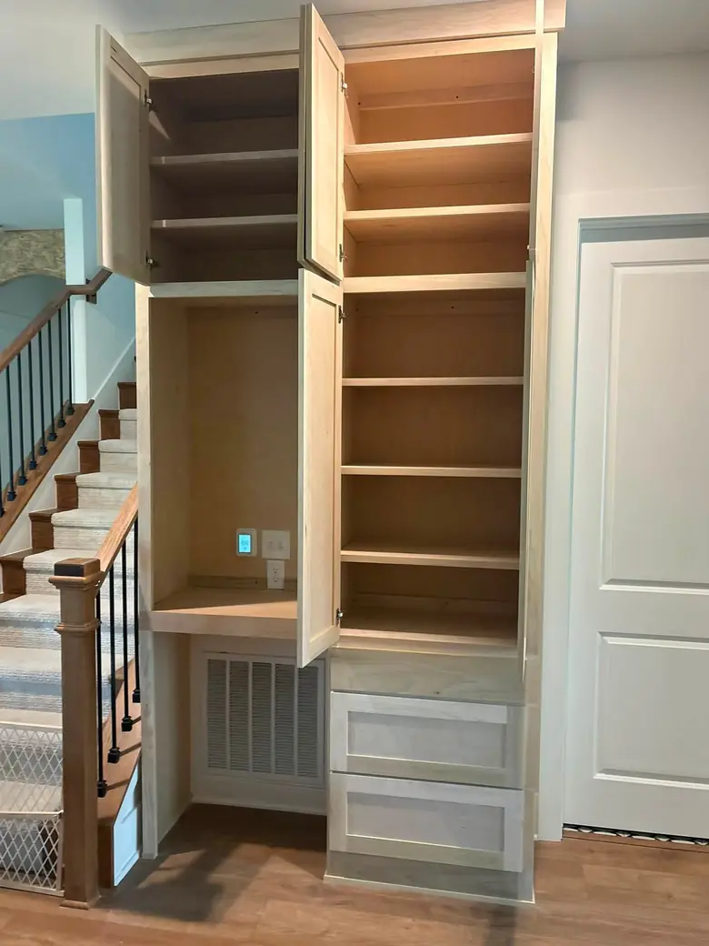 The installed built-in with all doors open, showing the completed shelving and drawers